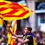 A boy waves a flag as people celebrate Catalonia's parliamentary vote to declare independence 