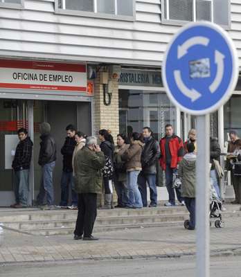 20 January 2010: People wait in line at a government employment office in Santa Eugenia, Madrid
