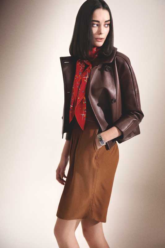 Jacket by Loewe, scarf by Hermès, dress by Azzaro, watch by Patek Philippe