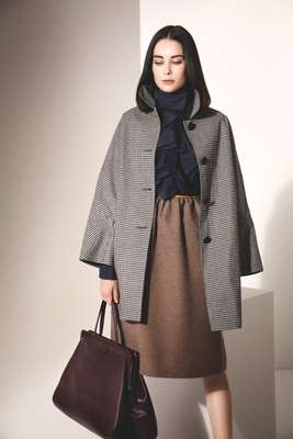 Coat by Mackintosh, dress by Fendi, bag by Valextra