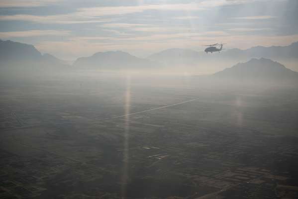 Helicopter flying over the mountains between Kabul and Herat