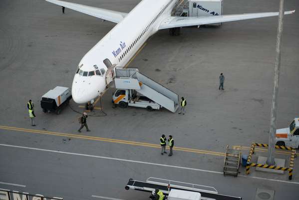 Airport staff preparing  a Kam Air plane