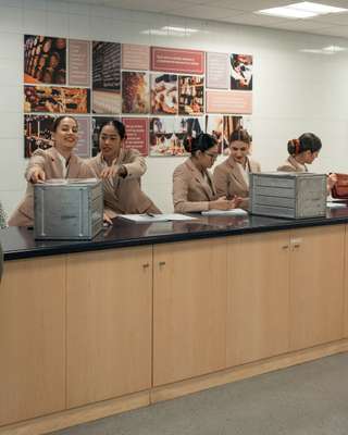 New flight attendants studying meal carts 