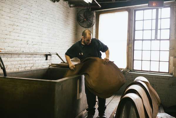 Employee preparing Shell Cordovan butts at Horween Leather
