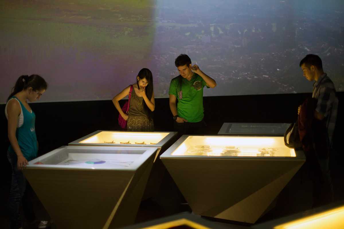 Visitors looking at exhibits in the House of Memory 