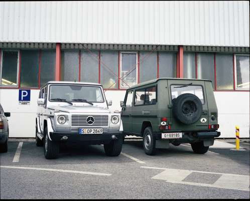 A finished G-Wagen next to a Puch model in army green