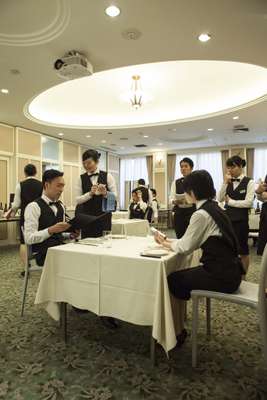 Students role-playing a restaurant service
