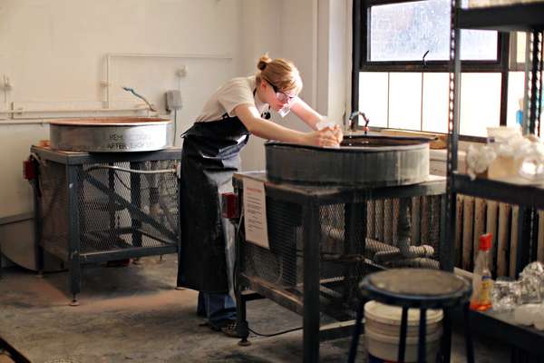 Hannah Kirkpatrick, majoring in glass, sculpts a piece in the ‘hot shop’  