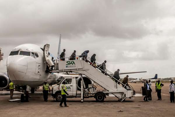 Passengers arrive on an international flight