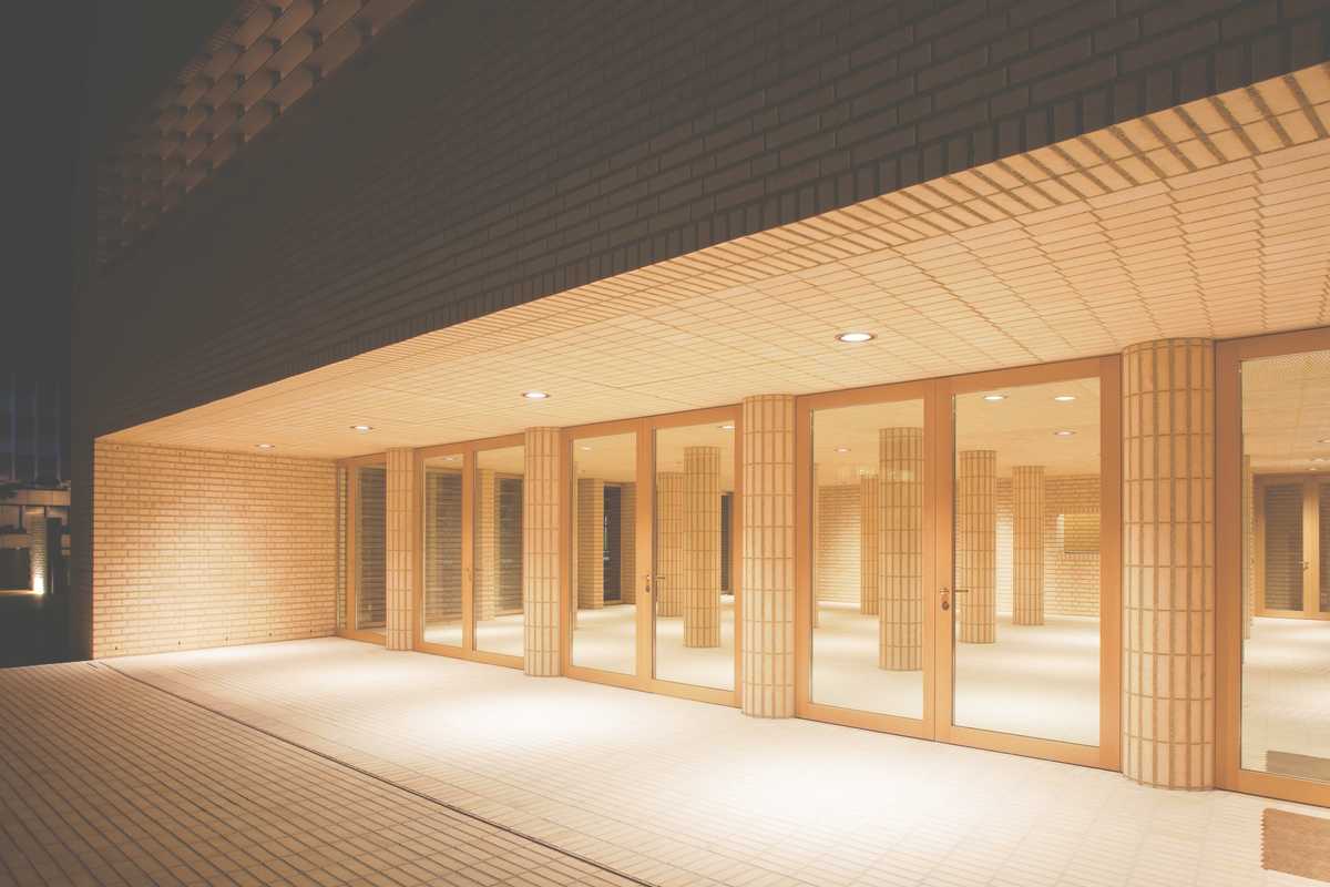 Main entrance opens onto a foyer of brick columns