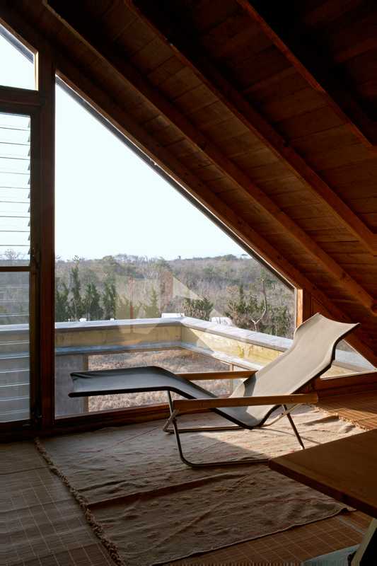 Third-sloor workspace: The workspace has stunning views to the sea. Folding chaise by Takeshi Nii. Ito specialises in design and architecture photography and co-authored *Mod East*, a record of Japanese architecture of the 1950s, 1960s and 1970s. 