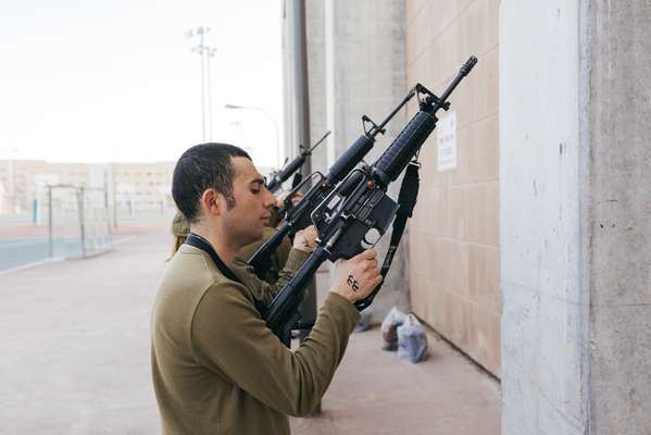 Soldiers learning how to handle weapons 