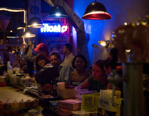 Drinkers at Grinders bar in Crossroads