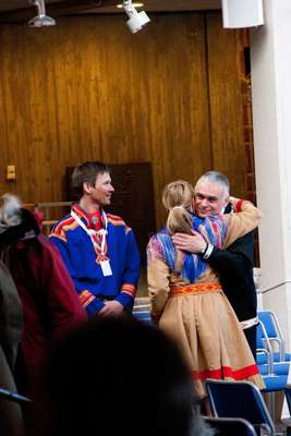 Sami delegation members greet a participant