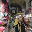 Two women walk past colourful underwear in the Grand Bazaar