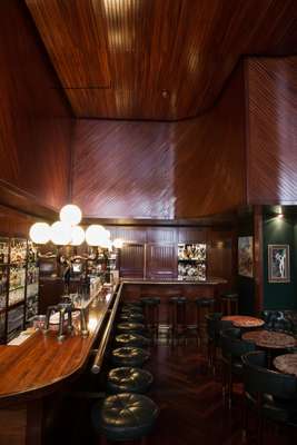 Bar with teak panelling and Giacometti lamp
