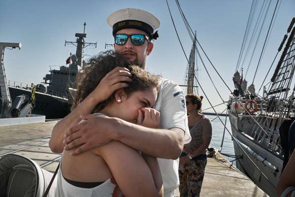 Sailor Diogo Amorim says goodbye to his girlfriend Danielle as the ‘Sagres’ prepares for its three-month deployment to Brazil 