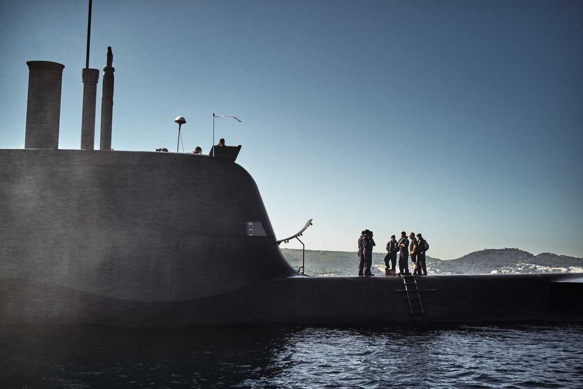 Submariners stand aboard the ‘Arpão’ as it surfaces off the coast of Portugal