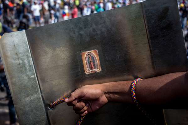 Virgin Mary stamp on a shield used in an anti-government protest 