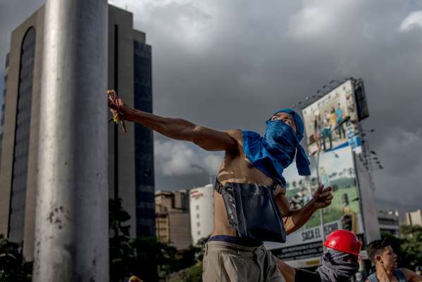 Protester catapulting a rock using a homemade slingshot 