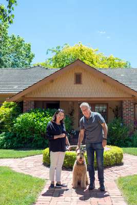 Bente (left) and Lee with their dog outside their home