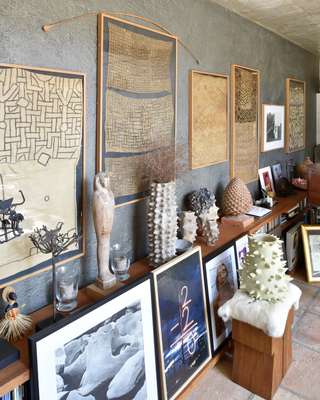 Wall in the living room showing African textiles and artworks from Menchu’s gallery days