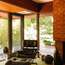 Vintage Eames Lounge Chair beside the indoor-outdoor fireplace in the study 