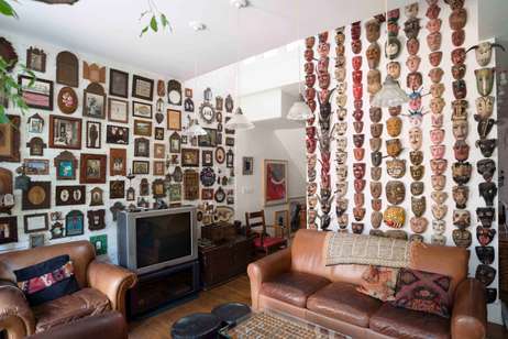 Art and travel mementos fill his walls