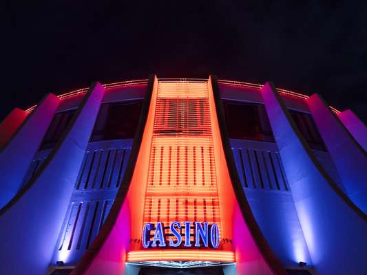 The casino’s neon sign signals that the floor is open