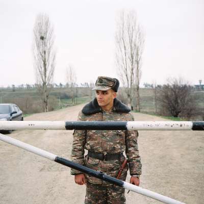 Armenian soldier guarding the entrance of a military base on the outskirts of Stepanakert