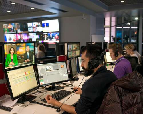 Editors and producers at work inside the newsroom
