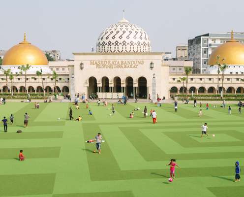 Families relax in the renovated Alun-Alun Park located behind Bandung's Grand Mosque