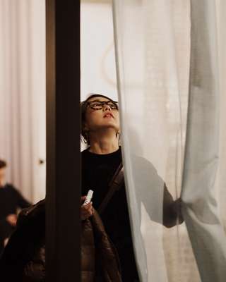 Visitor looking at curtains at IMM Cologne