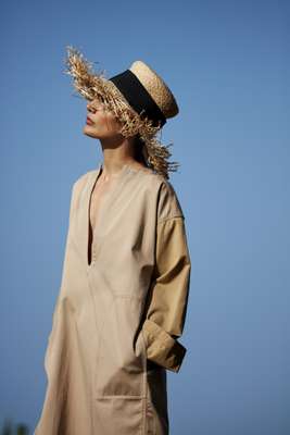 Tunic by Loewe, hat by Chanel