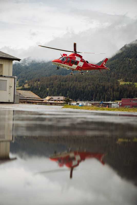 Rega helicopter taking off on a mountain rescue 