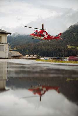 Rega helicopter taking off on a mountain rescue 