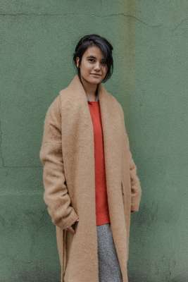 Camel side-tie coat and orange ribbed cashmere sweater