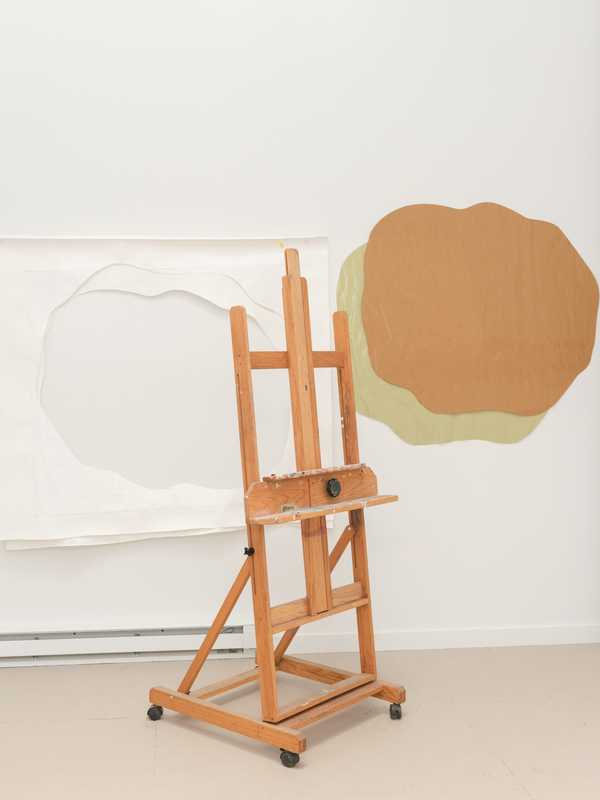 Easel with artwork in the background 