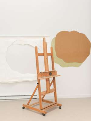 Easel with artwork in the background 