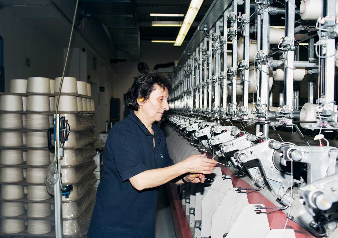 Employee twisting the threads during the spinning process