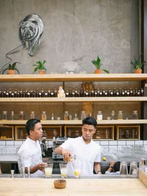 Staff at Three Buns burger restaurant in Jakarta prepare a cocktail