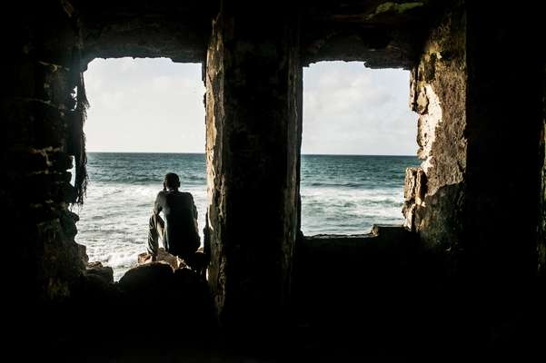 Somali man has a moment of calm looking out to se