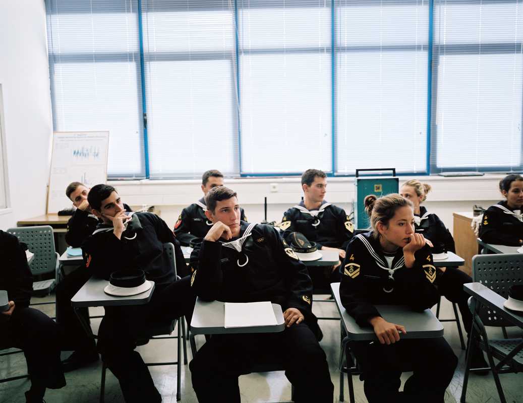 Naval academy students usually sit in class according to their grade