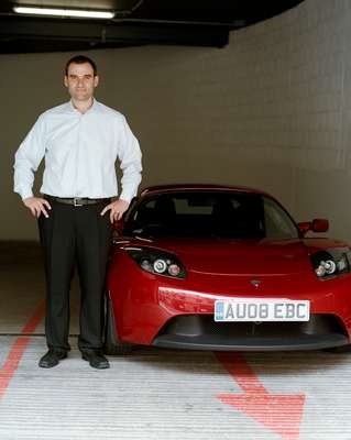 Darryl Siry with a Tesla car