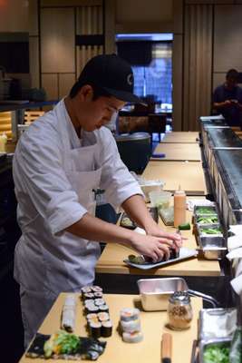 Chef preparing a dish at the sushi bar