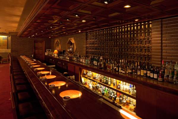 Polished cherry-wood counter of the Old Imperial Bar