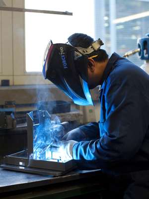 Folding and welding: workers fold and weld the pieces together to create the machine's shell