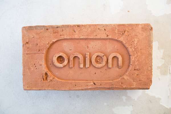 Custom-made brick with the Onion logo