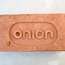 Custom-made brick with the Onion logo