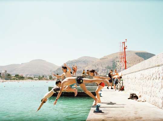 Leaping off the pier at Mondello Beach